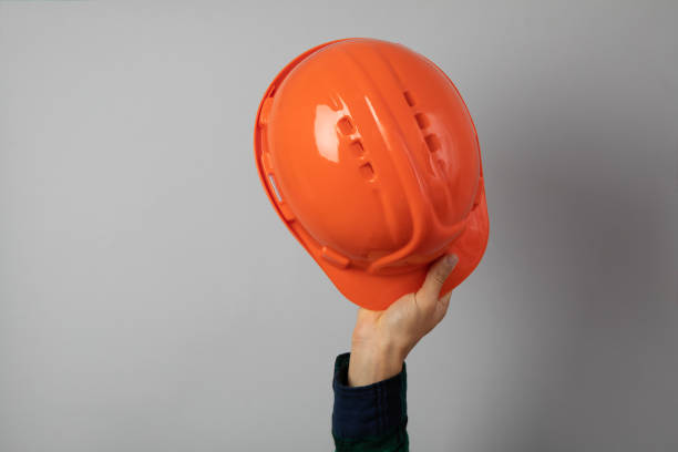 istock Hand hold safety helmet on gray background 1267311346