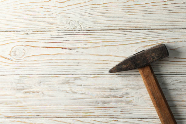 istock Hammer on white wooden background, space for text 1267312726