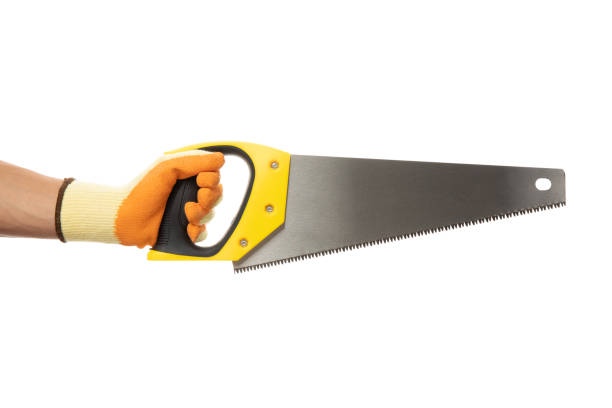 istock Hand in construction glove holds saw, isolated on white background 1267313009