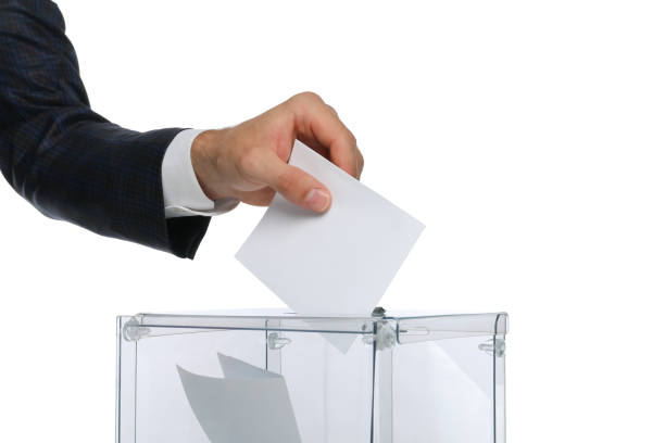 istock Man putting ballot into voting box, isolated on white background 1267313972