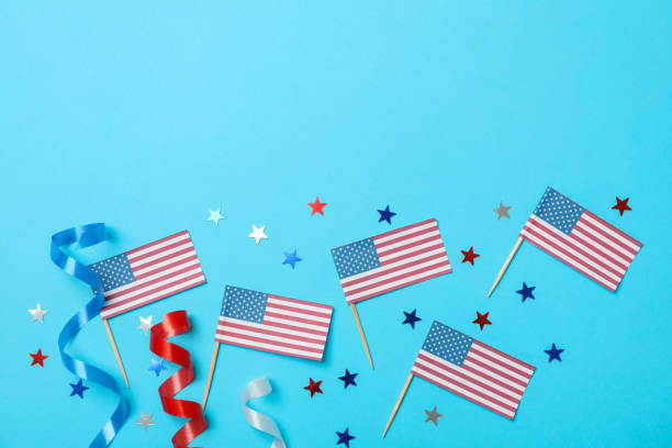 istock American flags, curly ribbons and stars on blue background 1267314087