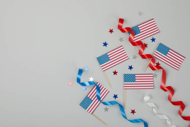 istock American flags, curly ribbons and stars on gray background 1267314390