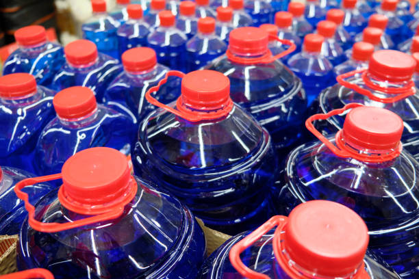 istock Dark blue fluid in the plastic bottles with red caps 1267315439