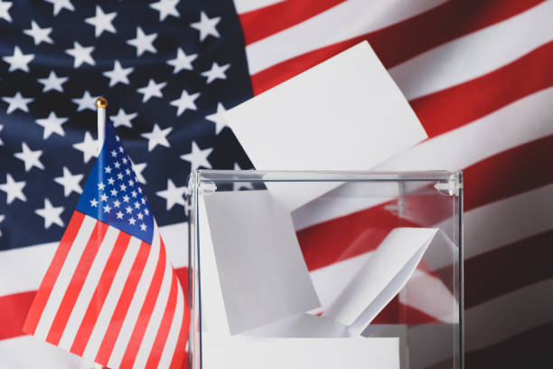 istock Voting box with bulletins on american flag background 1267315721