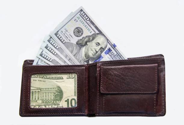 istock Dollars lie in a leather wallet on a white. 1267315880