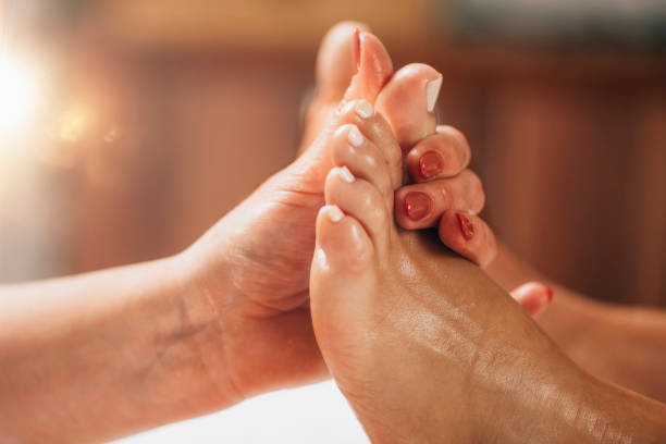 istock Reflexology Foot Massage. Reflexologist Applying Pressure to client’s Big Toe 1267315982