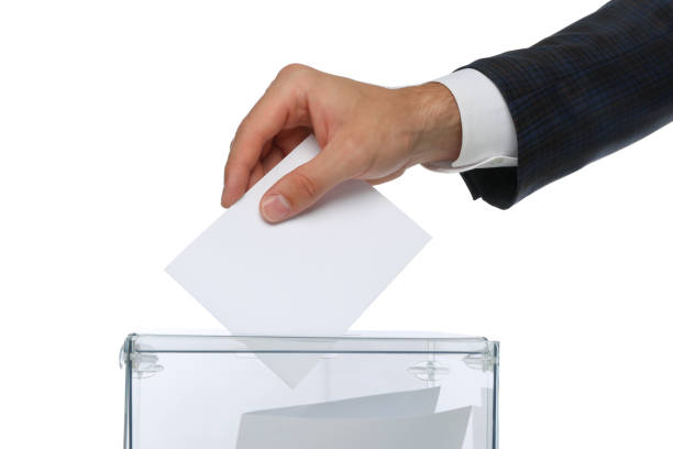 istock Man putting ballot into voting box, isolated on white background 1267316027