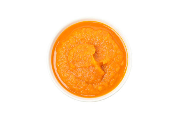istock Bowl of pumpkin soup isolated on white background 1267317687
