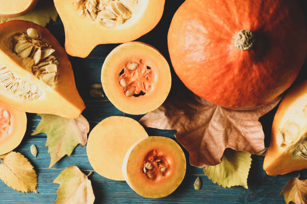 istock Composition with pumpkin, squash, seeds and leaves on wooden background 1267317785