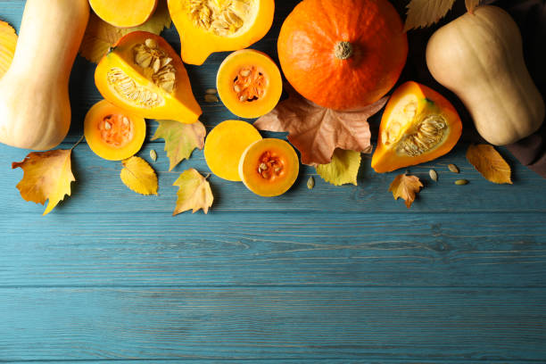 istock Composition with pumpkin, squash, seeds and leaves on wooden background 1267317819