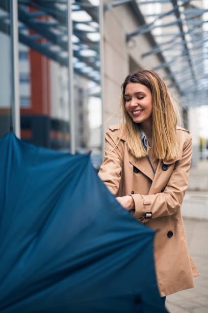 istock Smiling young women with umbrella 1267318709
