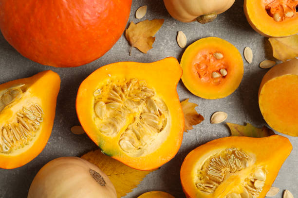 istock Composition with pumpkin, squash, seeds and leaves on gray background 1267318822
