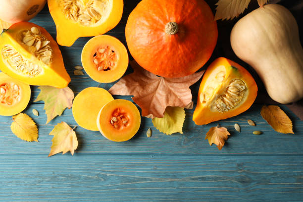 istock Composition with pumpkin, squash, seeds and leaves on wooden background 1267320004