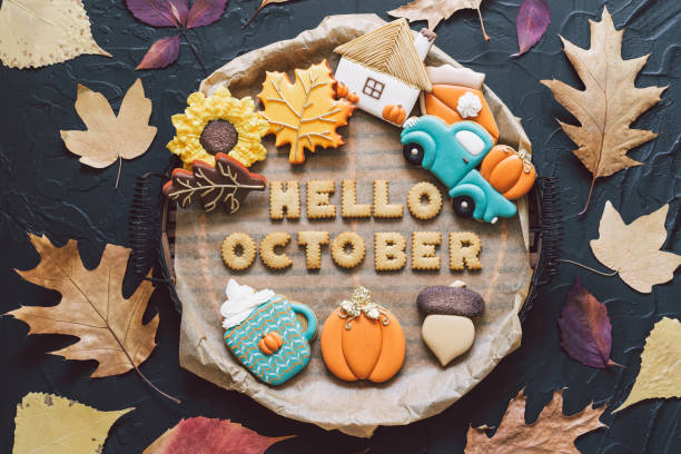 istock Hello October. Multicolored autumn cookies on a black background. Autumn concept 1267321714
