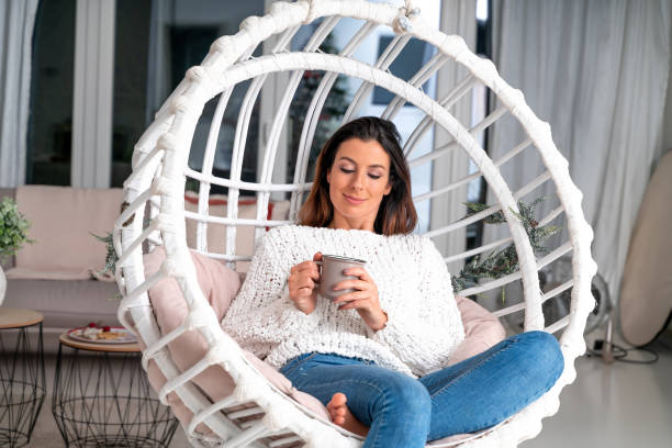 istock A happy woman having tea or coffee at home 1267325047