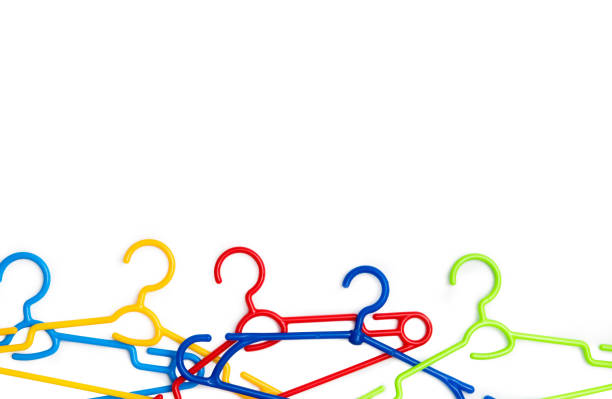 set of colorful plastic clothes hangers with text space isolated on a white background