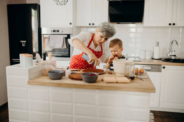 istock Grandma and grandchild bake cake 1267329260