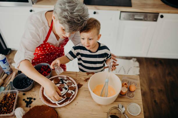 istock Grandma and grandchild bake cake 1267329357