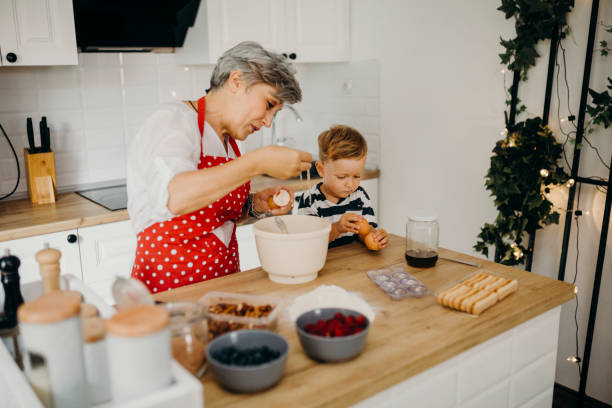 istock Grandma and grandchild bake cake 1267329663