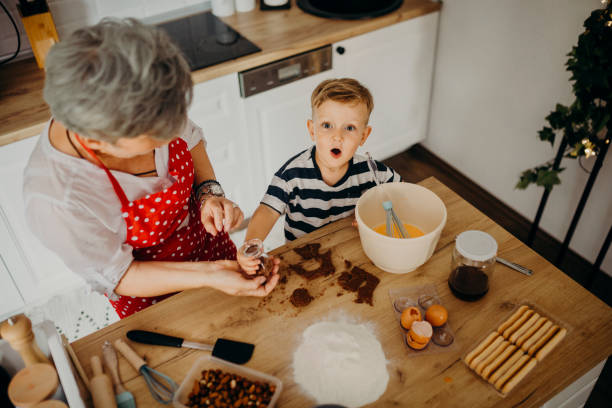istock Grandma and grandchild bake cake 1267329759