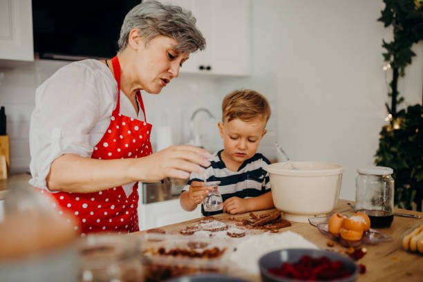 istock Grandma and grandchild bake cake 1267329799
