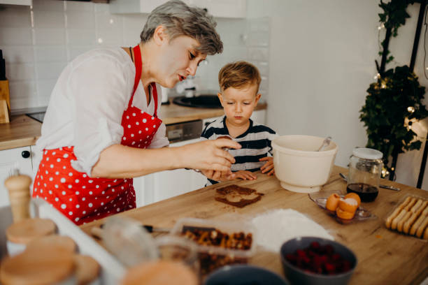 istock Grandma and grandchild bake cake 1267329906