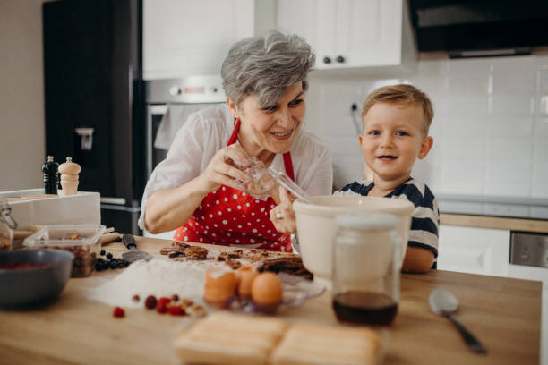 istock Grandma and grandchild bake cake 1267330001