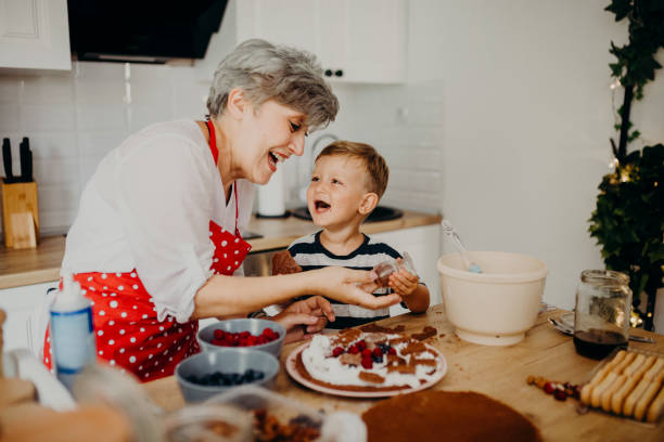 istock Grandma and grandchild bake cake 1267330023