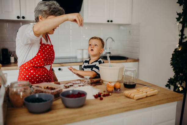 istock Grandma and grandchild bake cake 1267330044