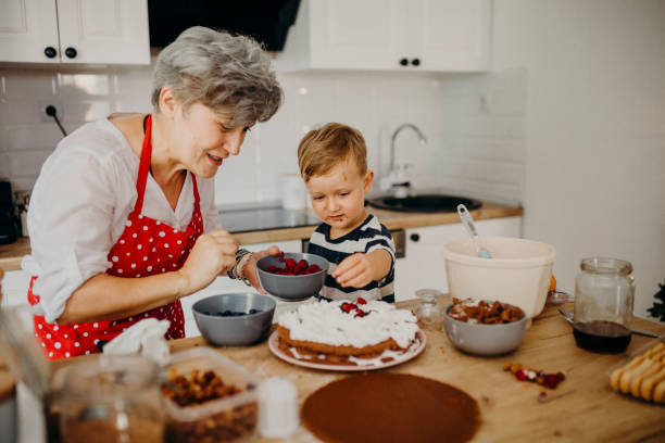 istock Grandma and grandchild bake cake 1267330104