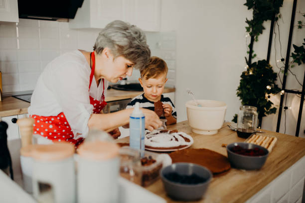 istock Grandma and grandchild bake cake 1267330238