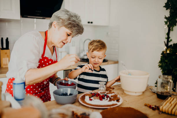 Grandma and grandchild bake cake stock photo