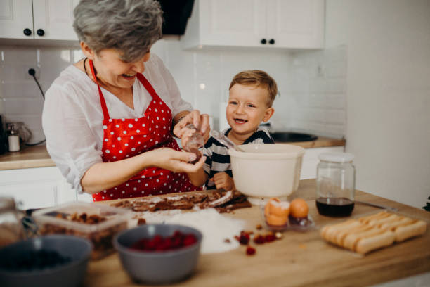 istock Grandma and grandchild bake cake 1267330350