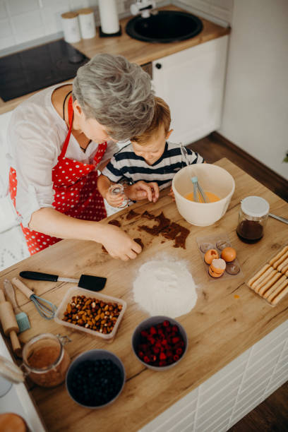 istock Grandma and grandchild bake cake 1267330457