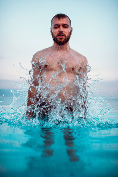 istock Male Splashing In Swimming Pool 1267333399