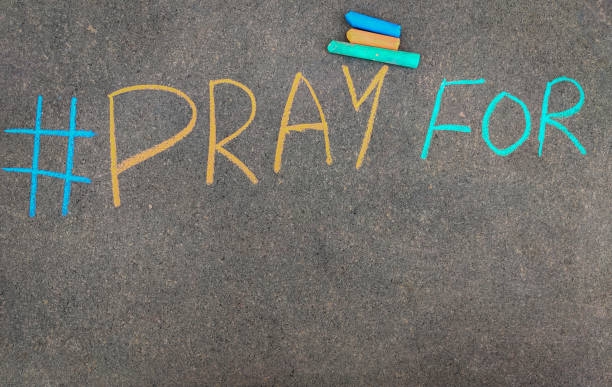 istock The inscription text on the grey board, #PRAY FOR. Using color chalk pieces.Copy space 1267334317