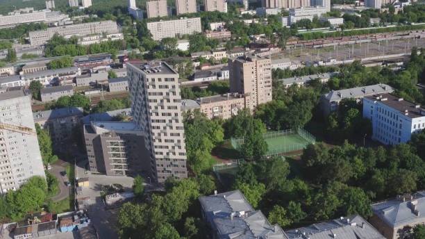 istock Drone footage of modern large apartment building. Development infrastructure city for big population, modern skyscrapers and tall edifices of megapolis, urban transportation system. 1267334364