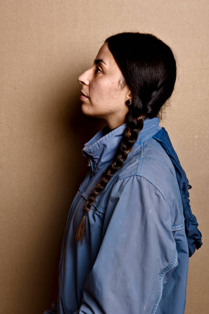 istock girl with blue jacket and without make up 1267338807