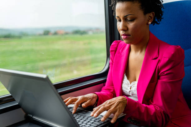 istock Mature woman using laptop on public transport 1267338869