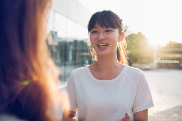 屋外で女性の友人とチャット - 語る ストックフォトと画像