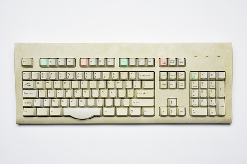 Old fashioned dirty computer keyboard on the white background