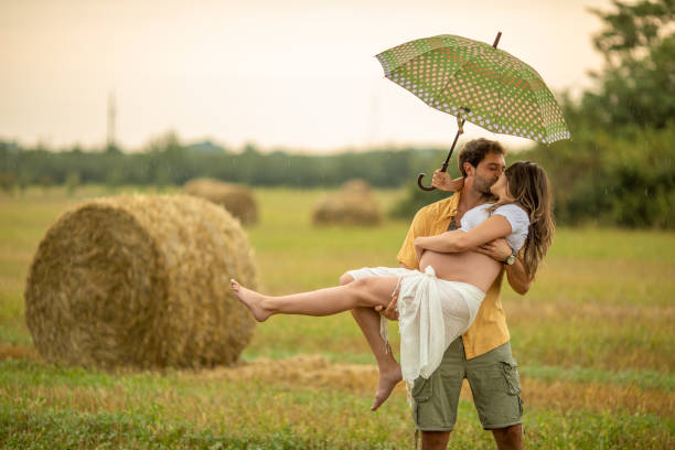istock Beautiful young couple at stubble field while expecting baby 1267340625