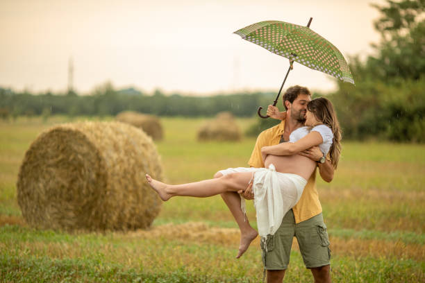 istock Beautiful young couple at stubble field while expecting baby 1267340642