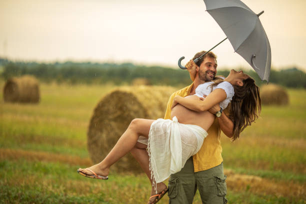 istock Beautiful young couple at stubble field while expecting baby 1267340669