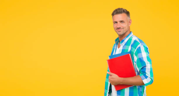 istock Man adult student. Final exam and graduation. Dedicated to studying. Student with textbooks. Regular student carry workbooks. Student life. Keep learning all life. College university education 1267340672