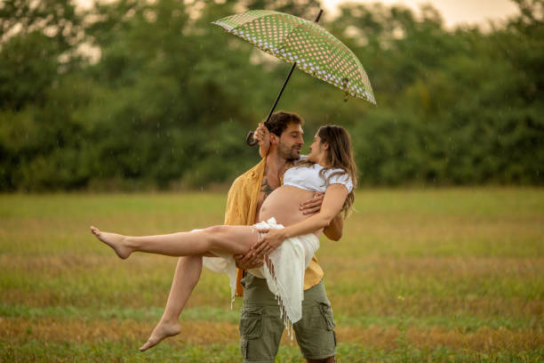 istock Beautiful young couple at stubble field while expecting baby 1267340676
