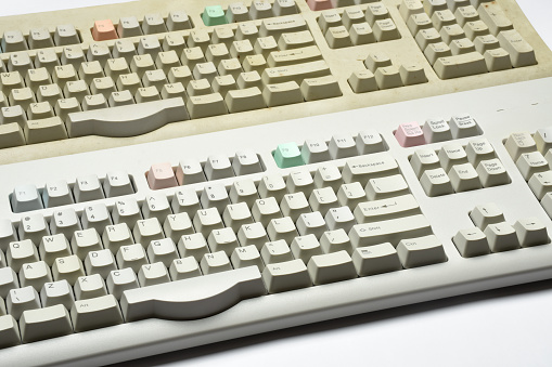 Old fashioned clean and dirty computer keyboards on the white background