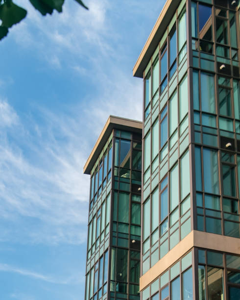 istock Side Facade of a Glass Building against a Blue sky 1267341850