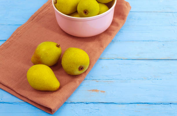 istock On a brown towel stands a purple deep plate with pears 1267342690