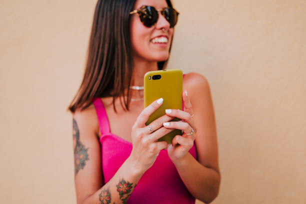 istock beautiful young woman outdoors using mobile phone. Technology and lifestyle 1267342745